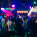 blurred silhouettes people dancing nightclub