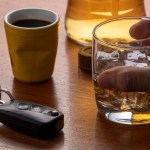alcohol abuse with glass whiskey with ice car key table