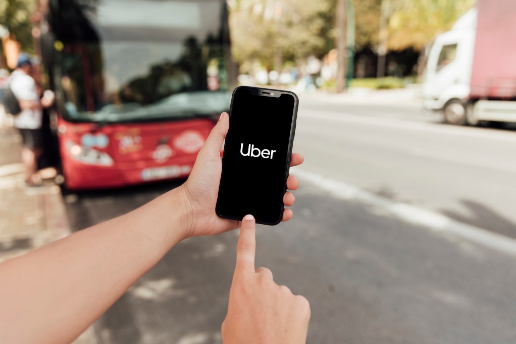 What Happens If You’re Injured as a Passenger in an Uber or Lyft? 2 close up finger pointing phone screen