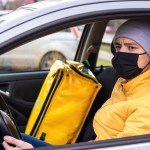 courier car with black medical mask delivery backpack seat food delivery service