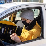 man car with black medical mask is his phone backpack seat