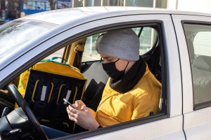man car with black medical mask is his phone backpack seat