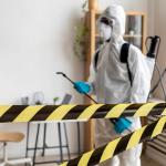 person disinfecting restricted area