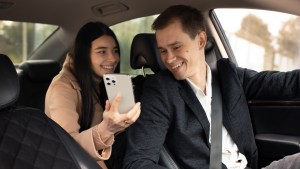 woman talking with taxi driver car