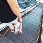 young woman standing escalator subway